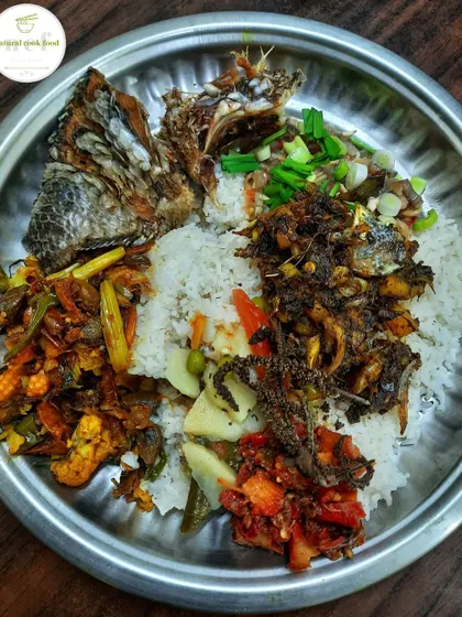 My plate with a little rice and lots of flavour. It includes a vegetable fry, spicy chutney, fried tilapia fish, and a fish head stir fry.