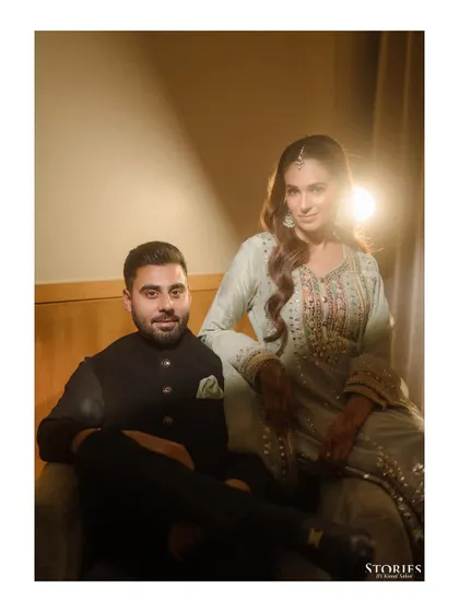 A dramatic, beautifully lit portrait of the couple, using a single light source to create a moody and intimate feel.