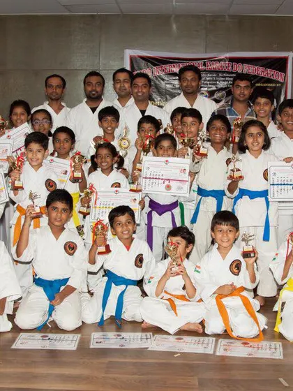 A group of our young champions, from yellow to blue belts, holding their trophies and certificates after a belt exam and competition. This shows the depth of talent across all levels in our academy.