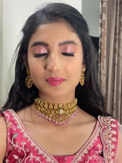 The shimmery eyeshadow really makes the eyes pop. This is a great look for any evening celebration or reception.