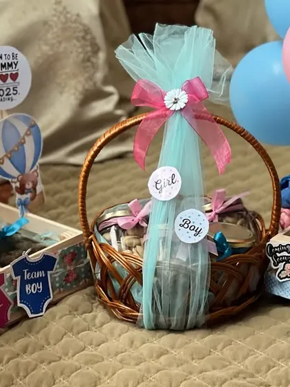A collection of my baby shower hampers ready for a celebration. You can see the different styles I offer, from rustic wooden crates to classic wicker baskets, all customized for the occasion.