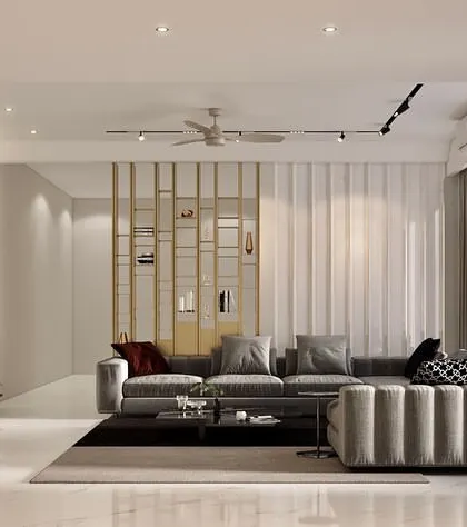 We designed this living room with a striking black marble feature wall for the media unit, creating a bold visual anchor. The space is balanced with a plush grey sectional sofa, fluted wall paneling, and a metallic partition for subtle separation.