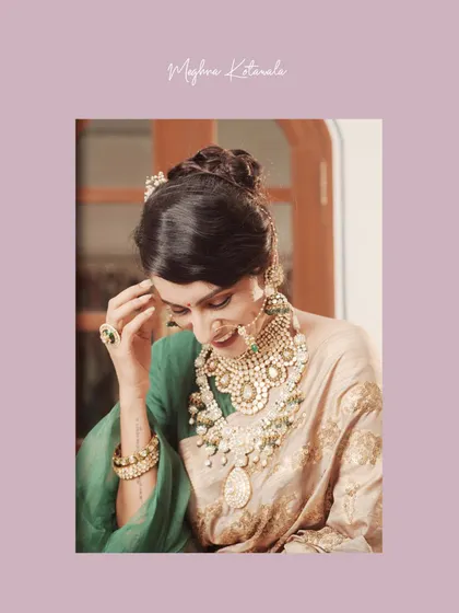 A close-up shot capturing the bride's joyful expression. The combination of her elegant green blouse, beige saree, and intricate gold and pearl jewelry creates a look of pure radiance.