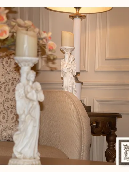 A pair of my Victorian angel candle stands, shown here to illustrate how they can be used to create symmetry and a harmonious, classic look on a side table or console.