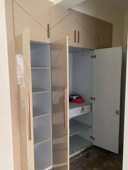 A look inside the four-shutter wardrobe, showing a combination of shelves, drawers, and hanging space to suit different storage needs.