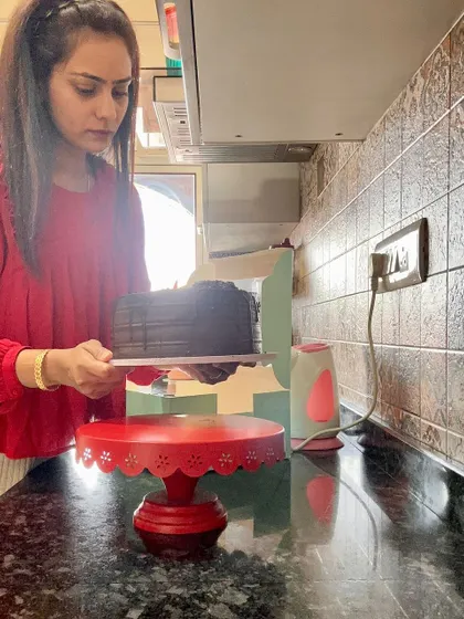 My obsession with making cakes never ends. Here I am in my kitchen, getting ready to box up a freshly made chocolate cake. I love every part of the process.