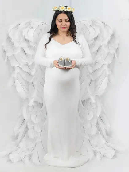 For a truly ethereal and angelic look, I use props like these beautiful white wings. Paired with a simple white gown and a bright, clean background, this style creates a serene and heavenly portrait of you and your little one.