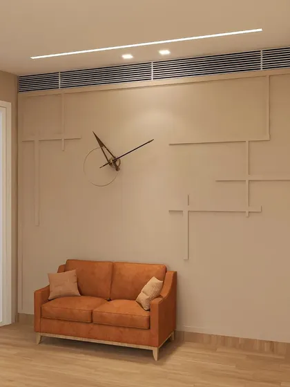 The waiting or breakout area of the office features a simple, elegant design. A geometric pattern on the wall adds a subtle artistic touch, creating a calm and welcoming space for visitors or for employees to relax.