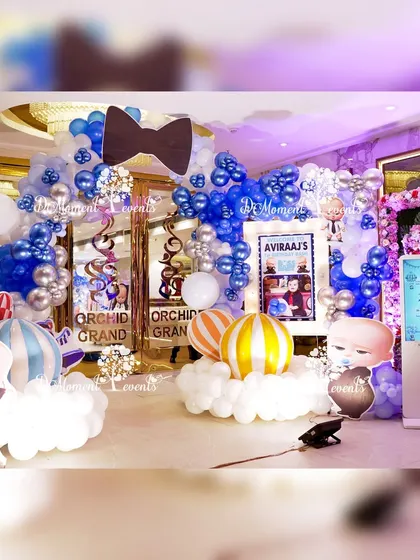 The grand entrance to the "Boss Baby" bash, featuring a large balloon arch with a bowtie accent, character props, and a personalized welcome sign.
