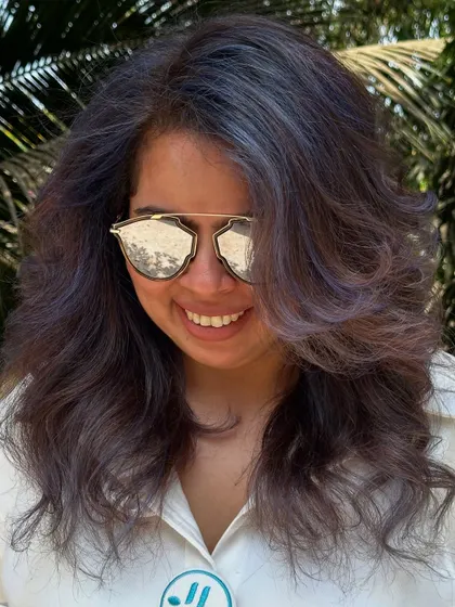A happy client with her experimental purple and ash hair.