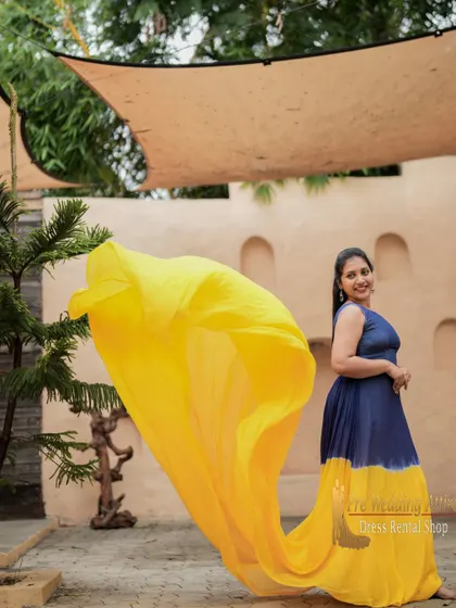 The blue and yellow dual-tone gown is captured here in mid-air, showing how the contrasting colors create a vibrant swirl. This gown is perfect for dynamic, action-filled shots.