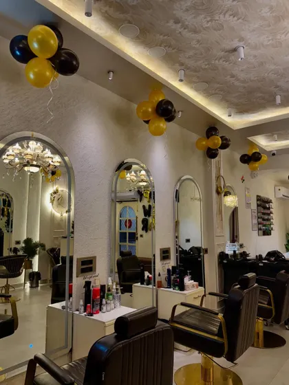 A view of our main styling stations. The salon features modern, arched mirrors and comfortable chairs, creating a luxurious environment for your hair transformation.