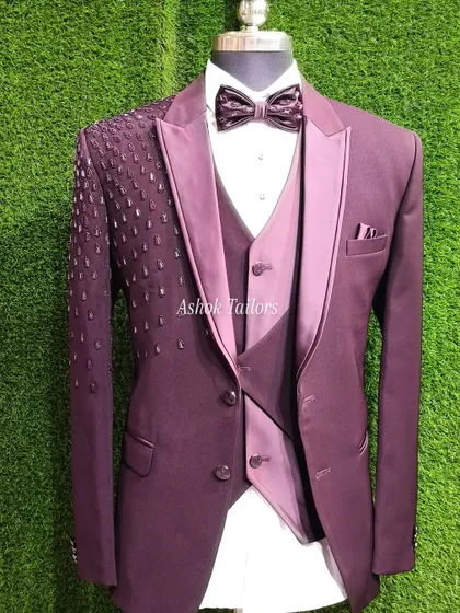 A full view of the maroon tuxedo with the sparkling shoulder detail. It's a perfect party-ready outfit.