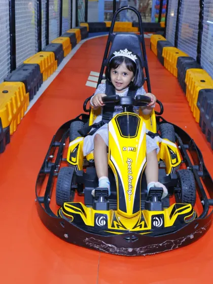 A little princess with her tiara on, proving that go-karting is for everyone who loves fun.