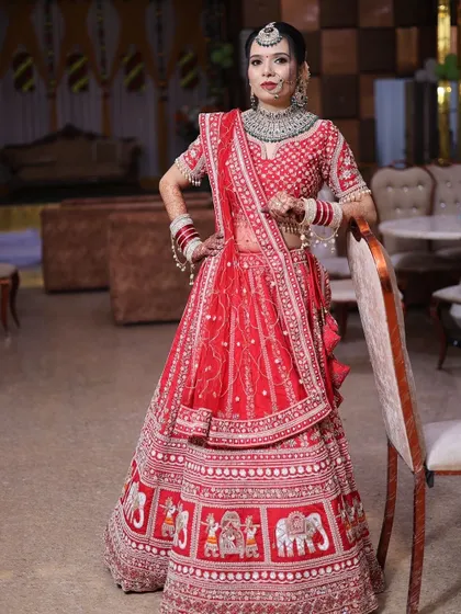 A confident pose by the bride. The makeup is bold yet elegant, perfect for a grand wedding celebration.