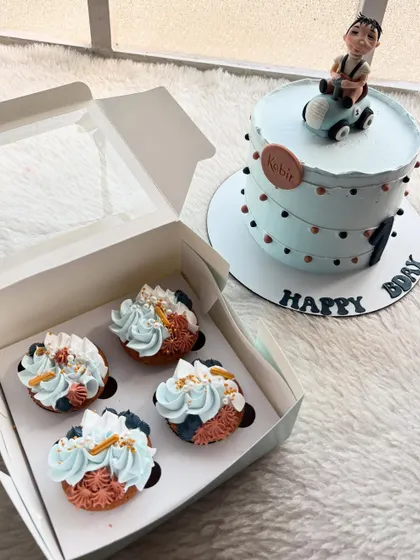 This order included a car-themed cake and matching cupcakes. It's a great way to coordinate the dessert table for a first birthday party.