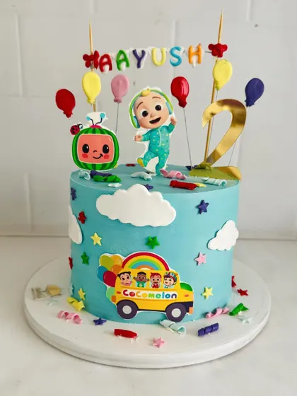 A sweet Cocomelon cake with JJ, the iconic watermelon, and a colorful school bus.