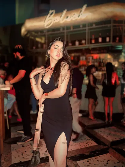Feeling the vibe with Karan Aujla's music in the background. A full-length shot of my black party dress, capturing the energy of a fun night in Delhi.