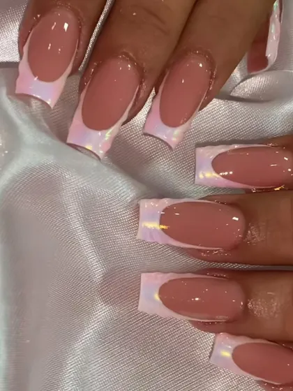 An iridescent dream. This French manicure uses a special foil on the tips that shifts in color, creating a magical, pearly effect.