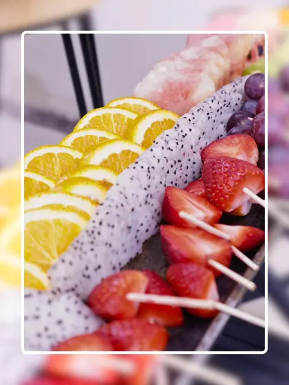 We believe in freshness you can see and taste. This platter features a vibrant assortment of sliced exotic fruits like dragon fruit, oranges, and strawberries, perfect for a healthy and refreshing option.