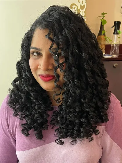 The final look is a testament to how a good cut can transform curly hair.