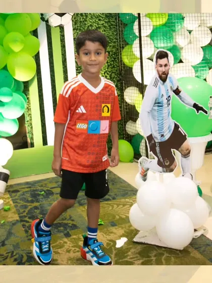 The birthday boy posing next to a life-sized cutout of his hero, Lionel Messi.