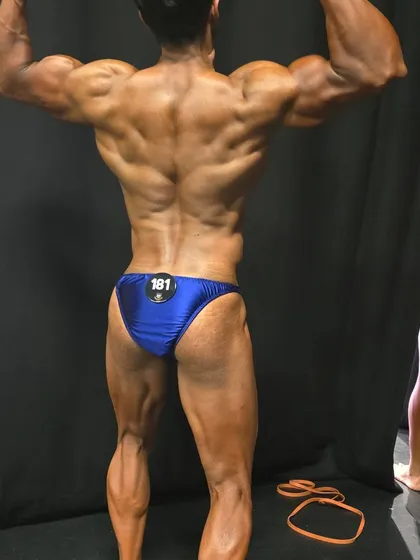 A back double biceps pose, showing the conditioning and muscle maturity achieved through years of natural training.