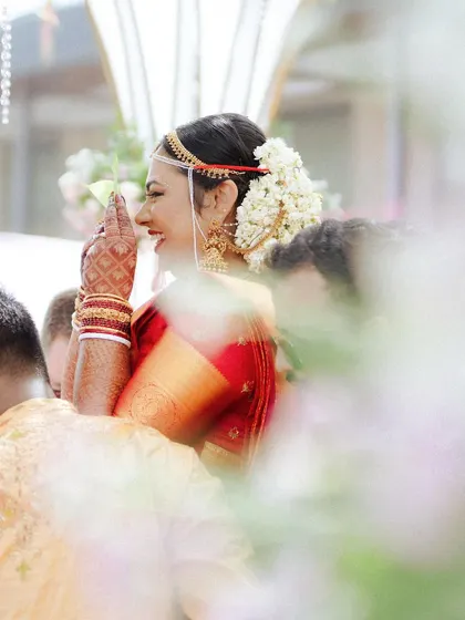 A candid shot of the bride's joyful reaction during her wedding ceremony, a moment of pure happiness.