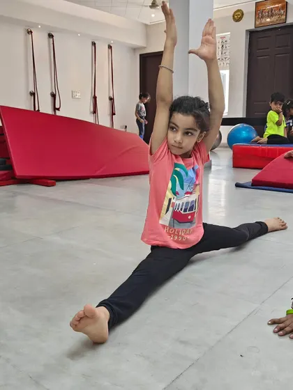 Look at this amazing progress. This young student is demonstrating a full front split, a result of consistent practice and flexibility training in my gymnastics class. I celebrate every milestone, big or small, because it builds a child's confidence for life.