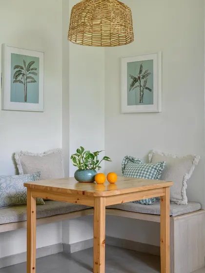 At one end of the 'House of Kismish' kitchen, we tucked in this cozy little breakfast nook. It's the perfect spot for quick nibbles or a morning coffee, complete with built-in bench seating.