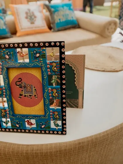 A small, hand-painted picture frame with an elephant motif, a charming detail that reflects the local artistry of Rajasthan.