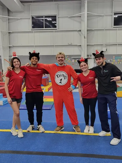 Our coaches posing together in their Dr. Seuss costumes. A happy and engaged team is key to creating a positive and fun environment for all our students and party guests.