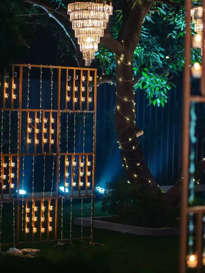 A closer look at the candle wall installation, where hundreds of diyas or candles create a warm and intricate pattern of light.