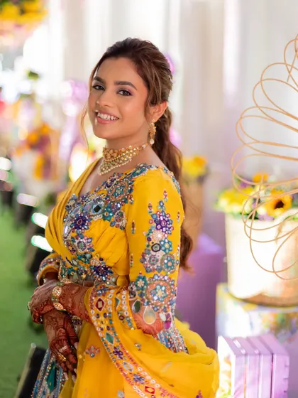 A textured, messy ponytail is a great option for a fun pre-wedding event like a mehendi or haldi. It's stylish, comfortable, and keeps the hair off the face.