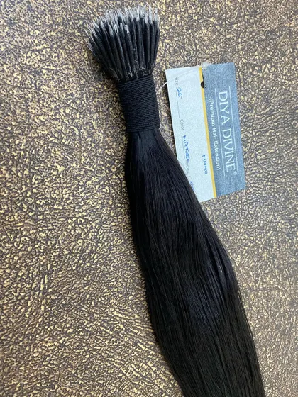 A close-up of a bundle of our premium nano-tip hair extensions. The tiny tips allow for the most discreet application, making them a favorite among clients and stylists.