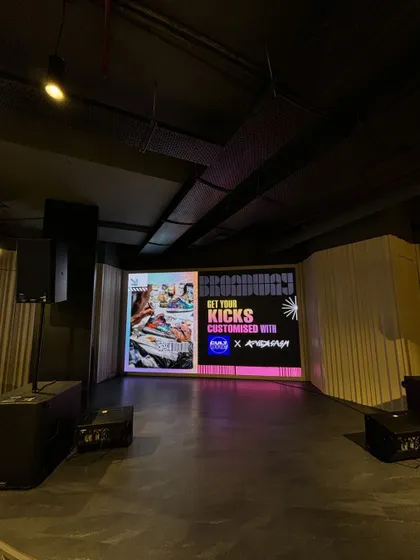 The full stage view before the event begins. Our setups are designed to look professional and exciting, building anticipation for the live art activation.