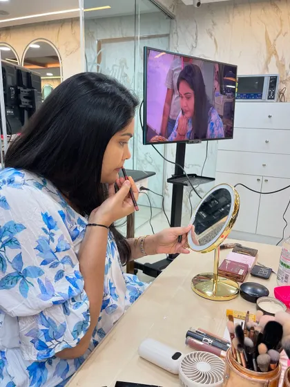I always demonstrate techniques on a model first, explaining each step clearly. Here, I'm teaching a self-makeup class how to apply lip liner for a defined and long-lasting lip color.