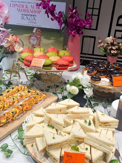 A closer look at the vibrant hi-tea grazing table for a workshop, featuring colorful veg sliders, mini sandwiches, and mini pizzas.