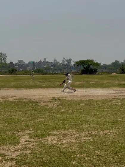 A batsman playing a powerful shot during the final.