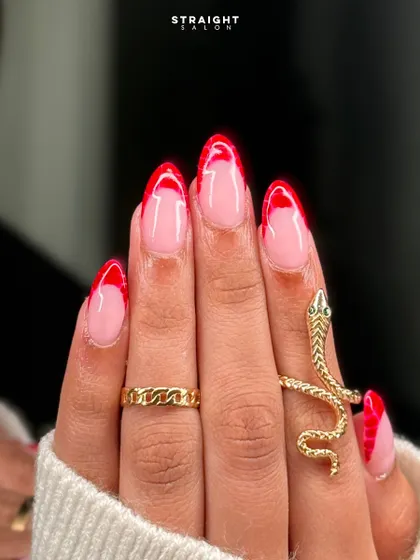 A close-up of the red croc-print French tips. The texture adds a unique and unexpected element to the design.