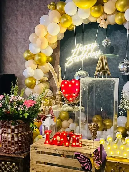 A close-up of the decor, showing details like the light-up "LOVE" sign and crown prop.