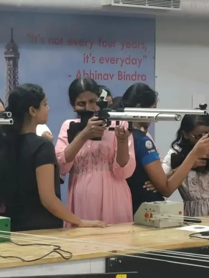 A group of employees from Healthium Medtech taking aim for the first time, focused and engaged in the activity.