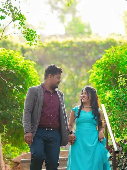 A romantic walking shot down a tree-lined staircase.