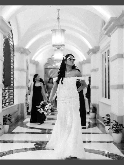 A bride with attitude. This fun, black and white shot captures her cool vibe, complete with heart-shaped sunglasses.