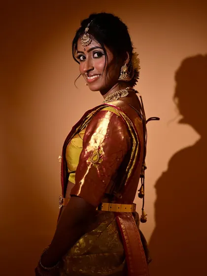 A profile view that shows the elegant hair styling and how the makeup enhances the model's side profile. The subtle contouring and glowing cheek highlight are key elements here.