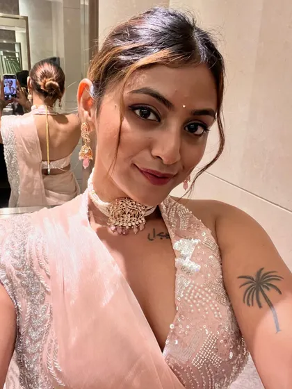 Another angle of this elegant pink saree look, showing the backless blouse design and the simple, chic hair bun. It’s all in the details when it comes to festive styling.