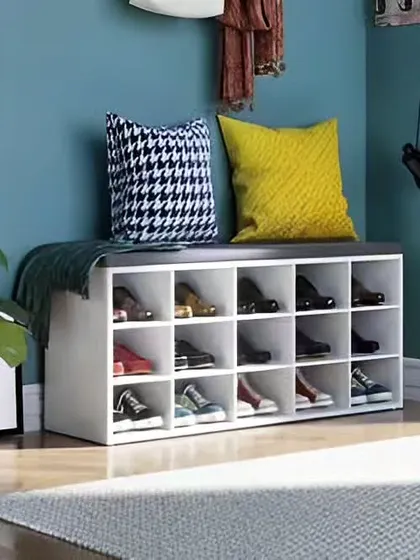 A simple and practical shoe storage bench for an entryway. The white cubby-style unit provides organized storage for multiple pairs of shoes and doubles as a convenient seating spot.