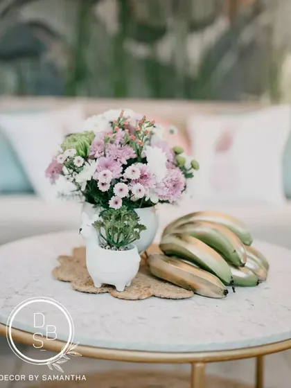 The pink and green color palette celebrated the couple's "opposites attract" love story. Even the table centerpieces, with tropical flowers and playful elements, reflected this theme.