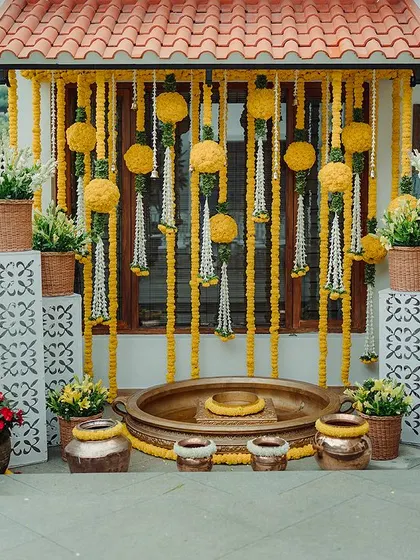 I transformed my client's residence into a floral paradise for their Haldi ceremony. The entrance is adorned with marigold balls, fragrant tuberoses, and temple bells, creating a warm and inviting atmosphere.