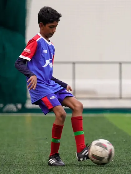 A player practices his first touch, a fundamental skill for controlling the game. Our coaches emphasize the importance of a clean and effective first touch.